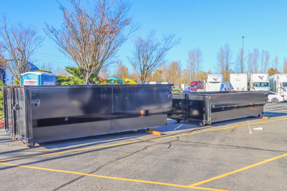 Professional dumpster rental service with roll-off container on residential driveway in Ellicott City